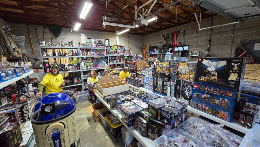 A garage staged wall to wall with boxed action figures, LEGO sets and collectibles