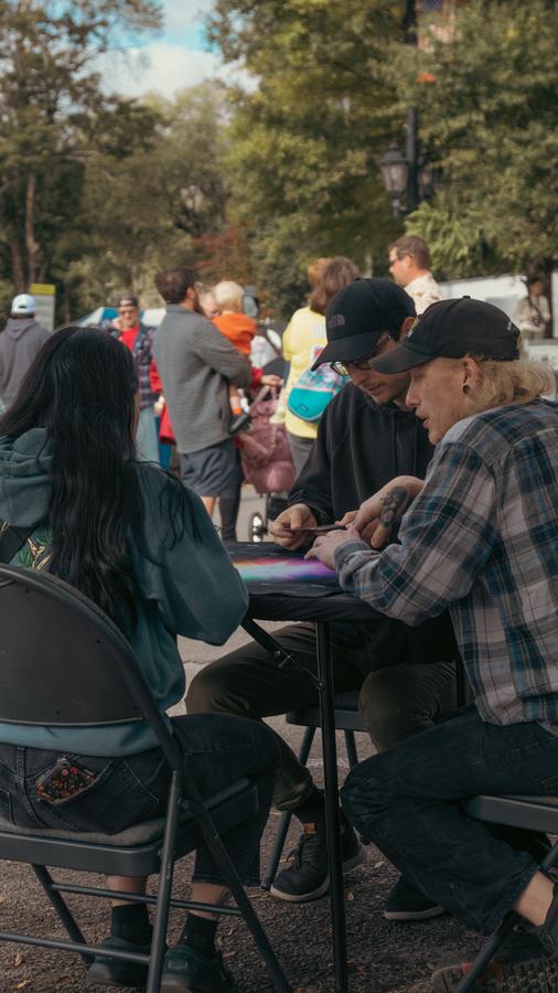 Card players at a folding table in the street