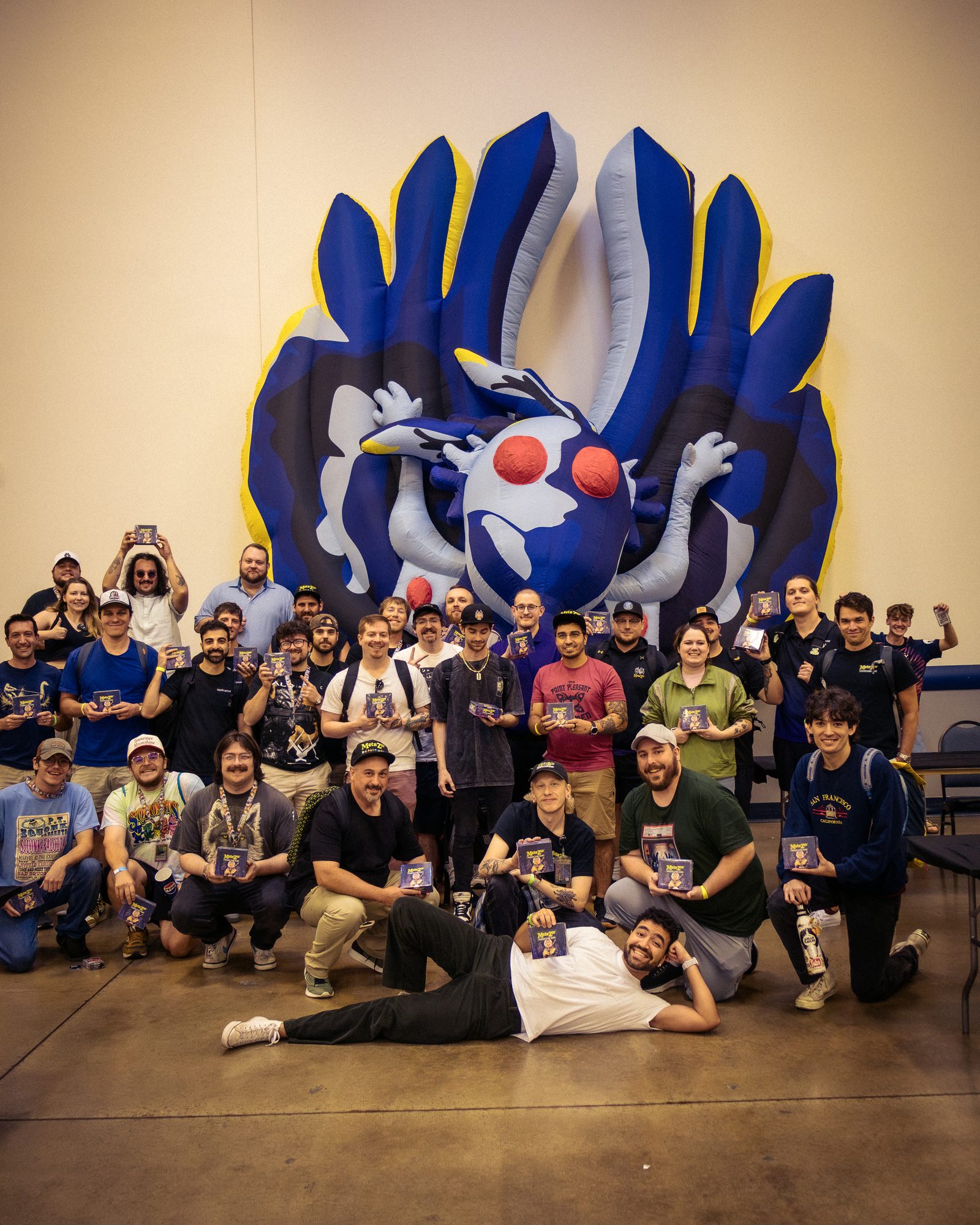 The players together beneath the inflatable cryptid