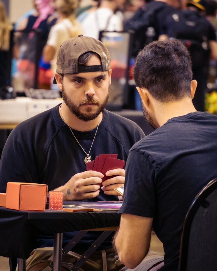 Holding a hand of cards across the table