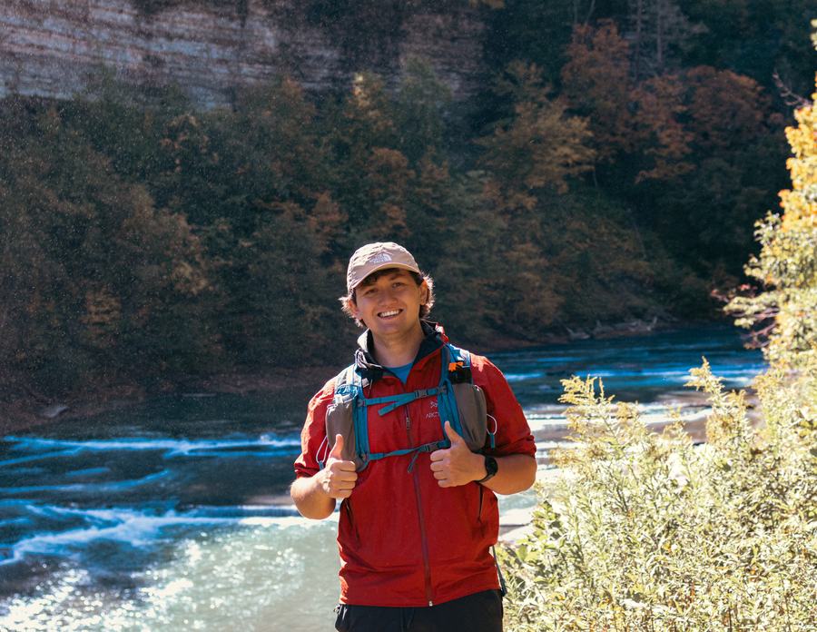 A thumbs-up above the rushing river