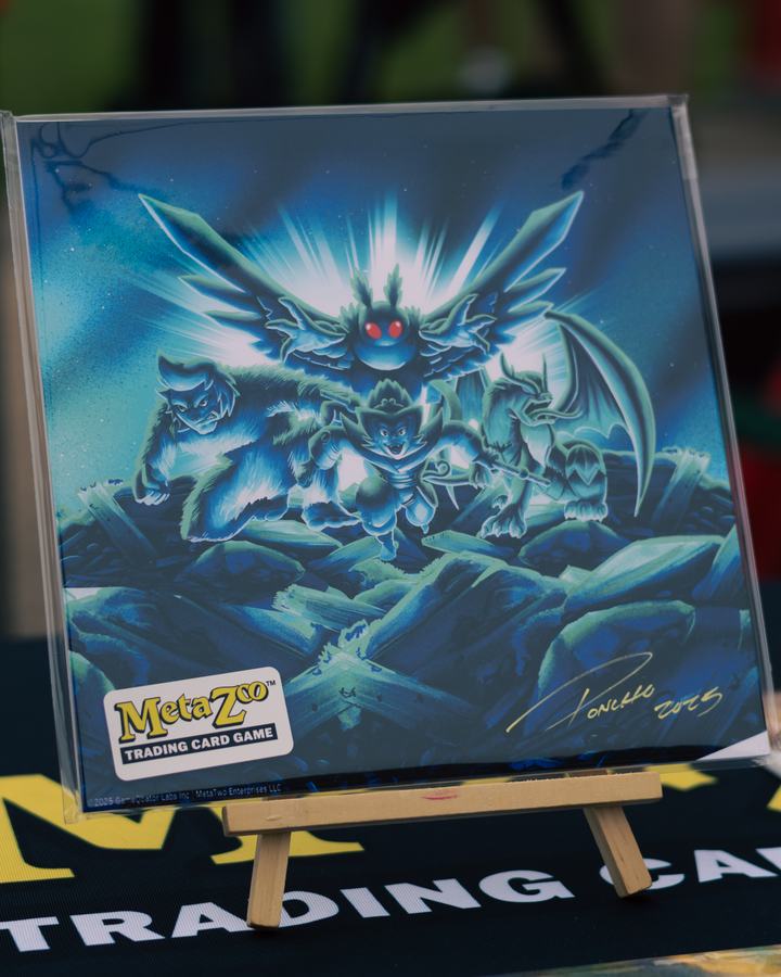 A signed MetaZoo Mothman print on an easel