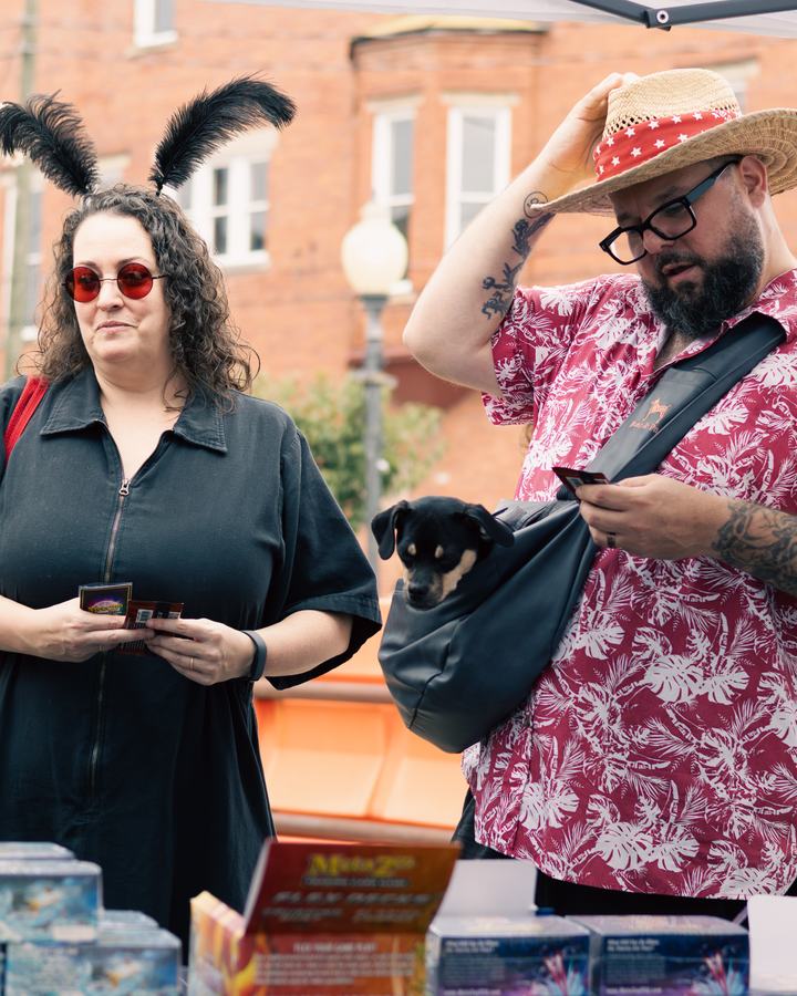 Festival-goers in feathered ears, and a dachshund in a sling