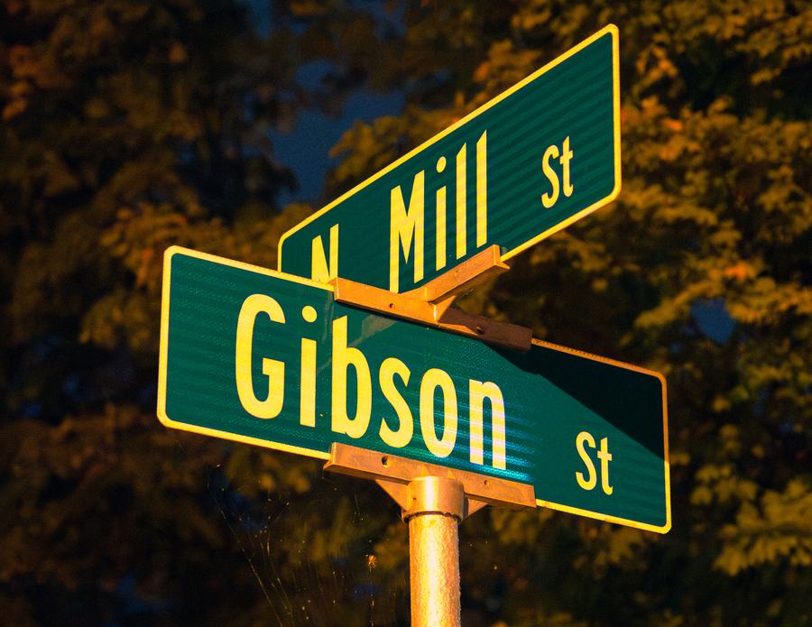 Street signs at the corner of Gibson and North Mill at night
