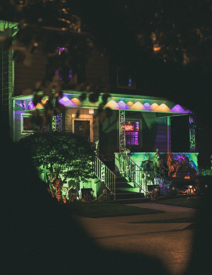 A porch glowing with Halloween lights