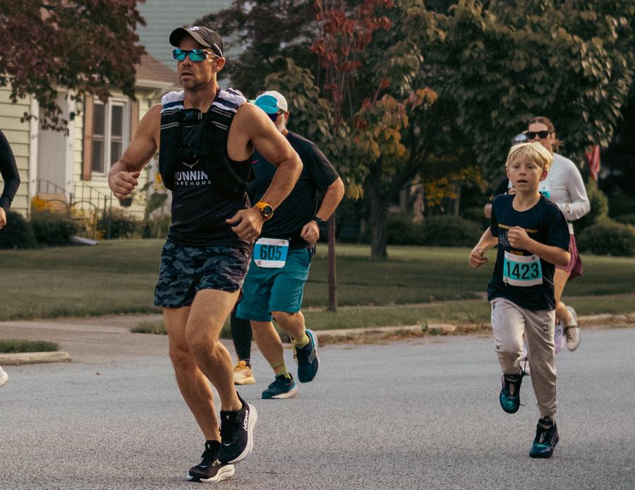 A runner and a young racer mid-stride